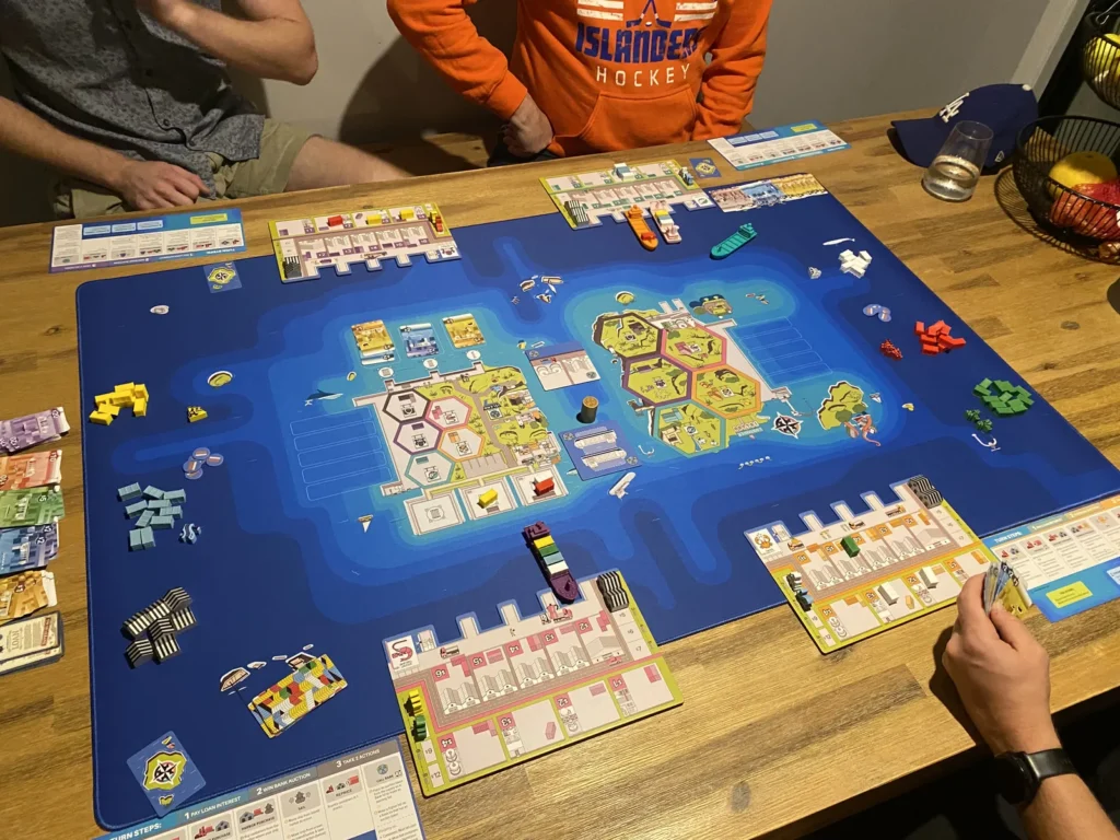 a game of Container on a huge playmat of the sea and islands