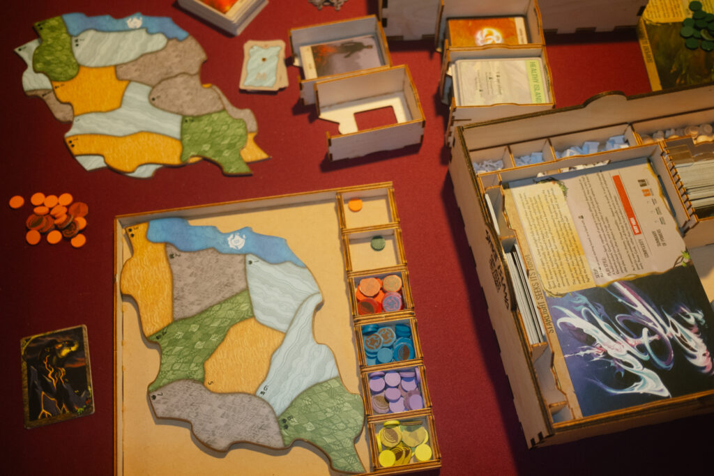 setting-up-a-game-of-spirit-island-on-a-red-board-game-table